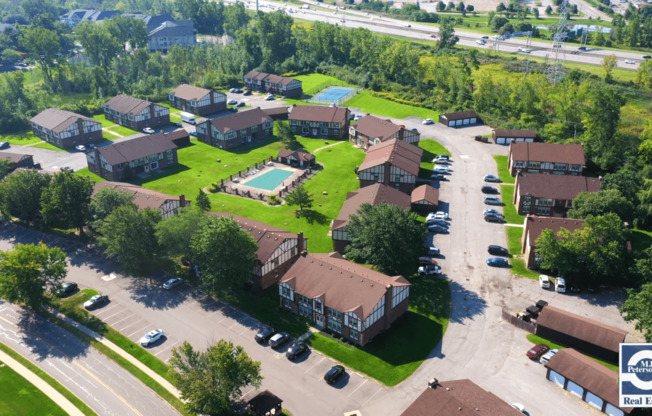 an aerial view of a neighborhood with houses and a pool