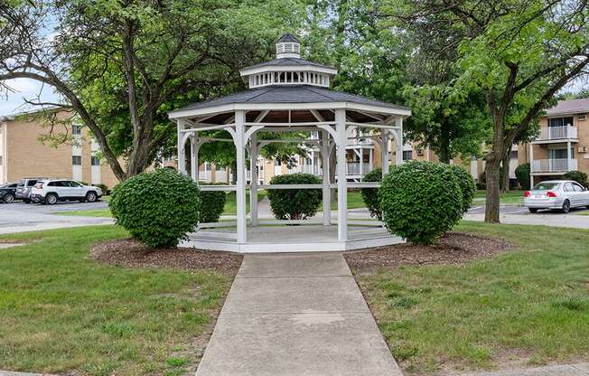 a white gazebo in the middle a community