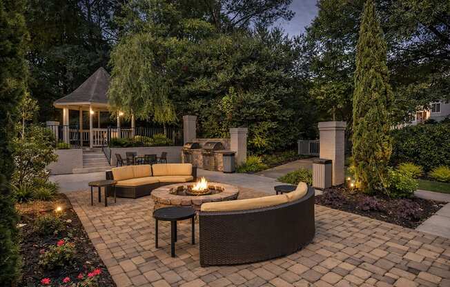 A backyard with a fire pit and seating area.