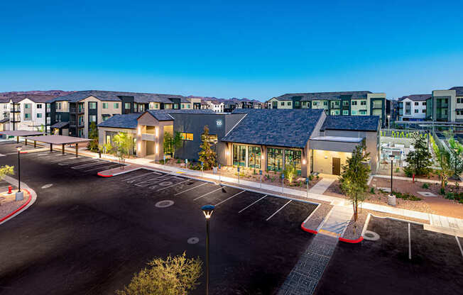 a building with a parking lot and a street in front of it