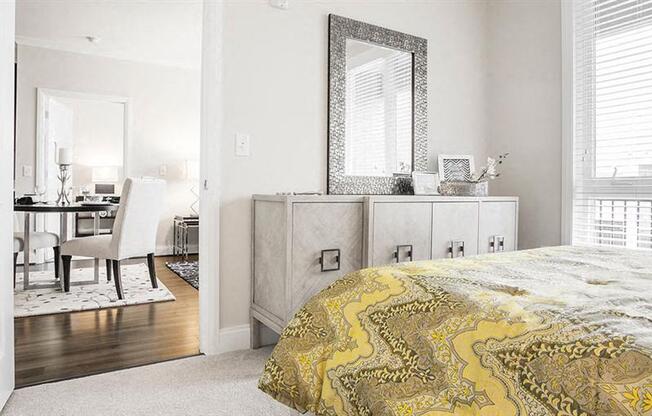a bedroom with a bed and a mirror