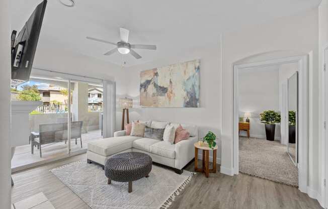 a living room with a couch and a ceiling fan