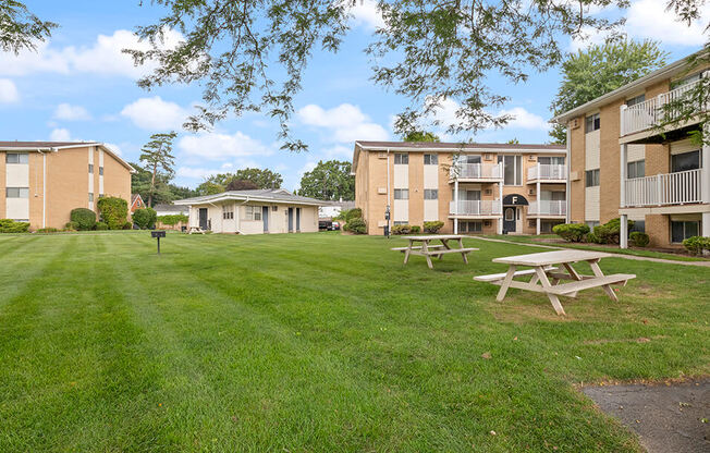 our apartments are located in a grassy area with picnic tables