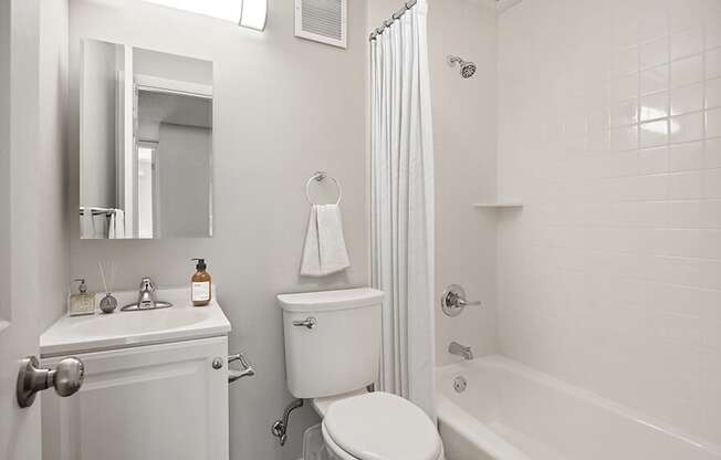 Model Bathroom with Bathtub/Shower, Wood-Style Flooring & White Cabinets at Elevate on Parkway, Burnsville, MN, 55337