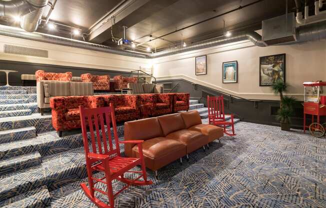 a large room with red chairs and couches and a seating area