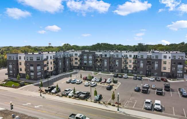 a view of a parking lot with several apartment buildings in the background