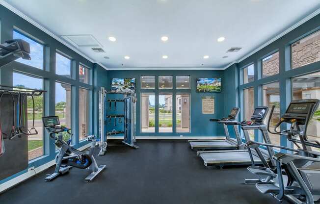 A gym with treadmills and exercise bikes.