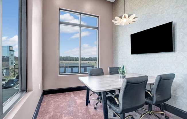 a conference room with a table and chairs and a window
