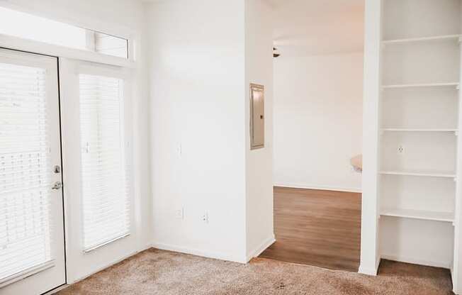 a bedroom with white walls and a closet with white doors