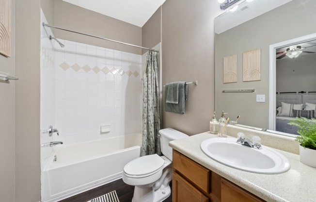 Secondary bathroom with tub/shower combo located  at Sugarloaf Crossings Apartments in Lawrenceville, GA 30046