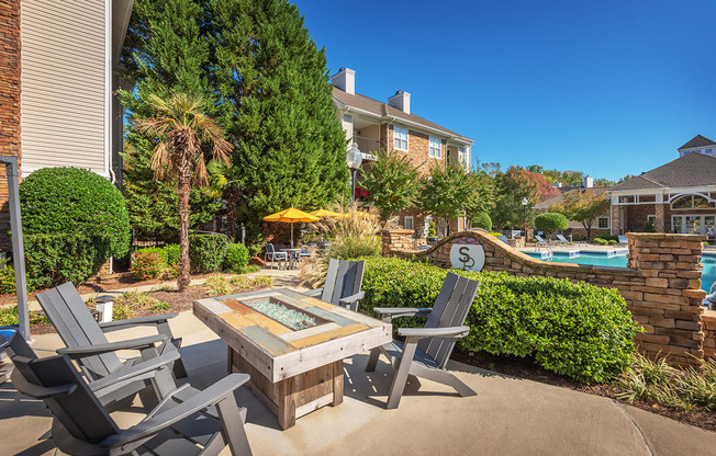 a patio with a table and chairs near a swimming pool