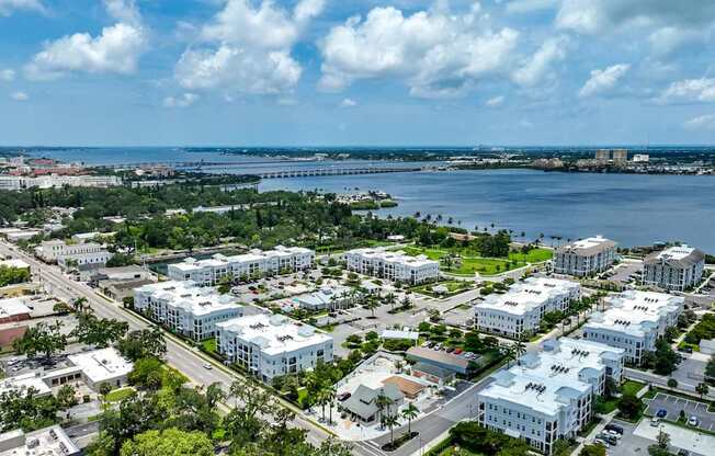 A view of a city with buildings and a body of water.