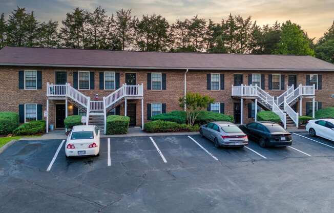 an apartment building with cars parked in front of it