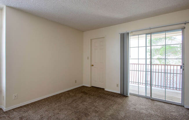 Living Room with Balcony at Park Place Apartments in Las Cruces