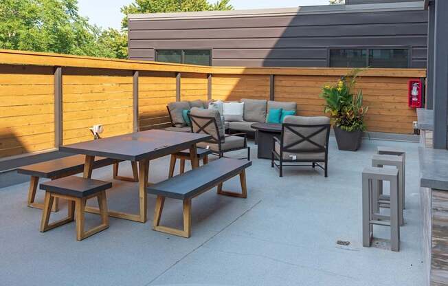 A wooden table and benches are set up on a patio.