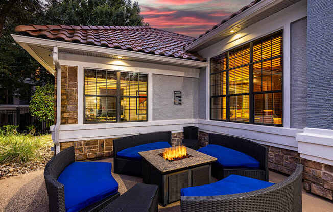 A patio with a table and chairs is set up outside a house.