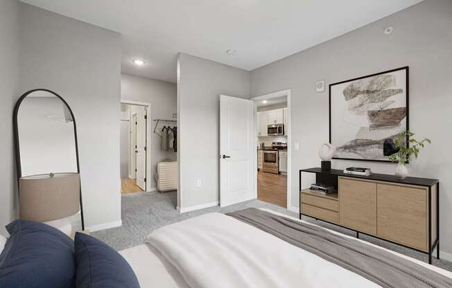 A bedroom with a large bed and a mirror on the wall.