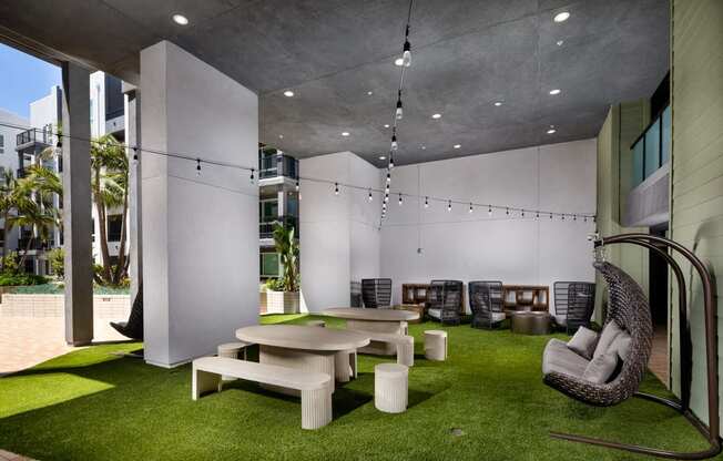 A modern outdoor seating area with a white and green color scheme.