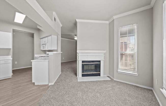 A spacious living room with a fireplace and a dining area.