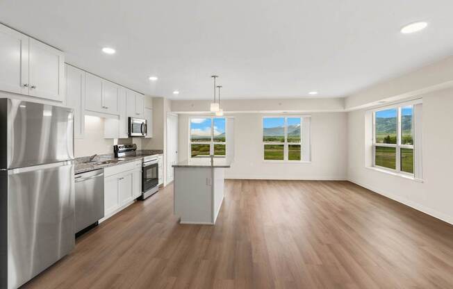 A kitchen with white appliances and wooden floors.