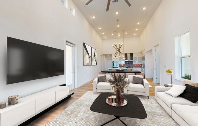 a living room with white furniture and a tv on the wall