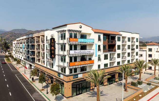 A multi-story building with a white facade and a red roof.