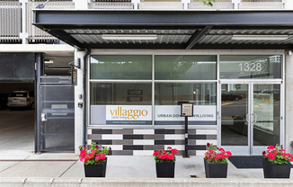 the exterior of the property with a black and white checkered tile and plants in front at Villaggio Apartment Homes, WA 98402