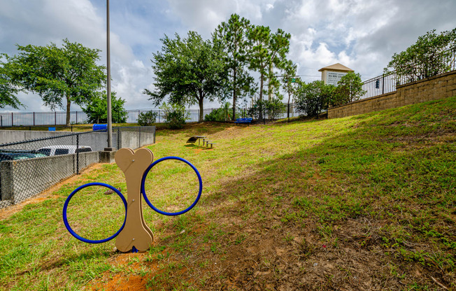 a playground with a pair of olympic rings in the grass