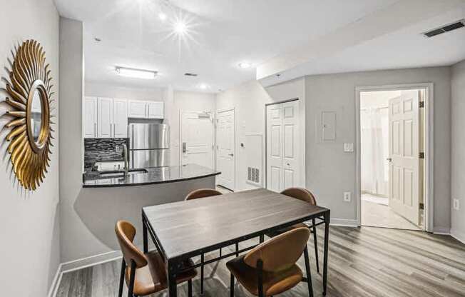 a dining room and kitchen with a table and chairs