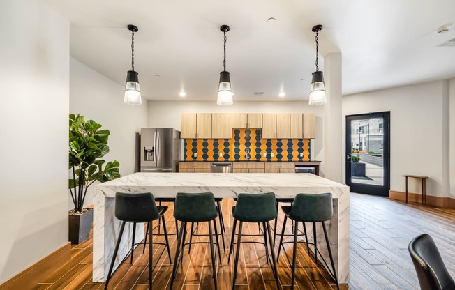 a kitchen with a large island and bar chairs