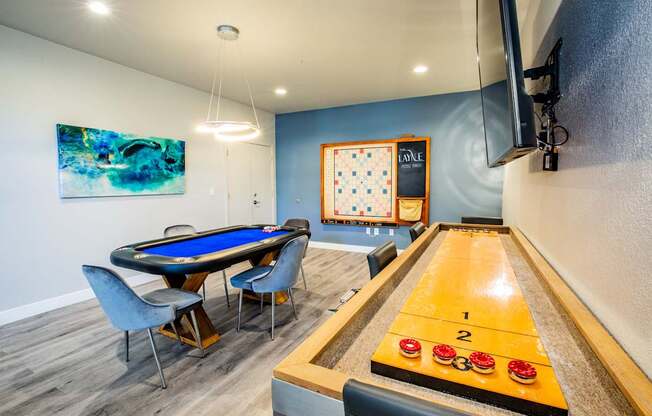 A pool table with a blue cloth and a cue ball in the middle of the table.