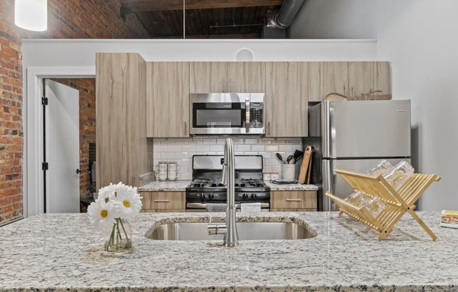 a kitchen with a large island with a sink and a stove