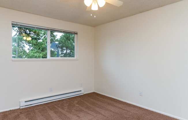 Pinewood Terrace Apartments | First bedroom with carpet and window