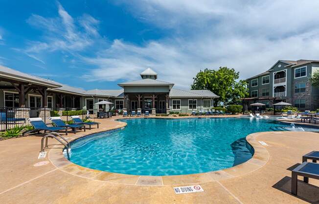 A pool with a sign that says "NO DIVING" on the ground.