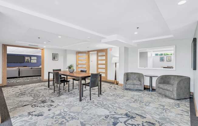 a living room with a dining room table and chairs