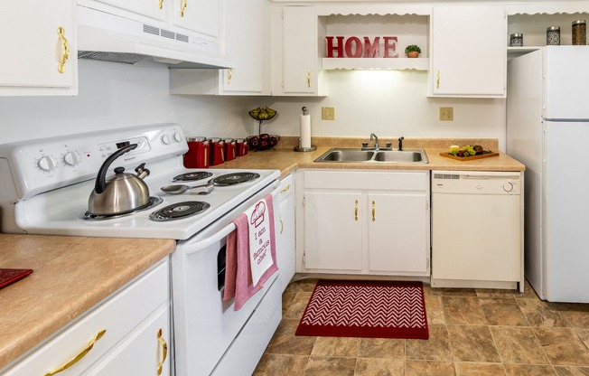 a kitchen with white appliances and white cabinets