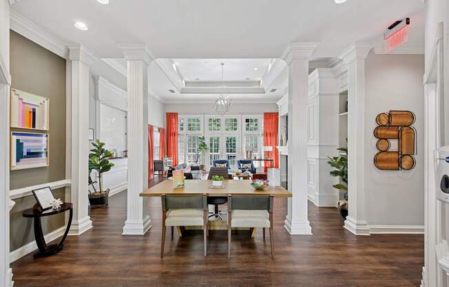 A large room with a long table and chairs in the middle.