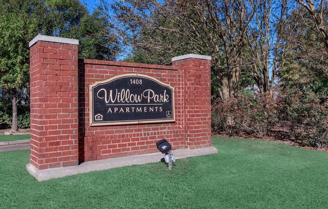 a large lawn in front of a brick building