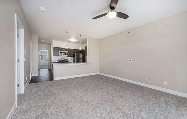 open living room with a ceiling fan at Trade Winds Apartment Homes, Elkhorn, NE