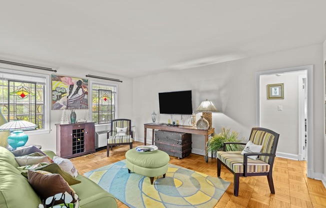 a living room with a couch and chairs and a television