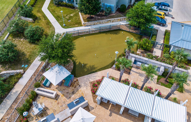 an aerial view of the koi pond and patio at the whispering winds apartments in pearland