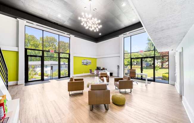 A spacious room with wooden floors and a variety of seating options.