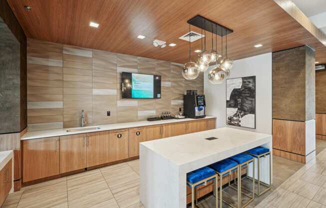 a large kitchen with a white counter top and a sink