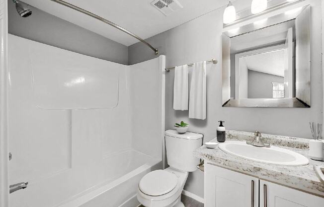 a white bathroom with a sink and a toilet