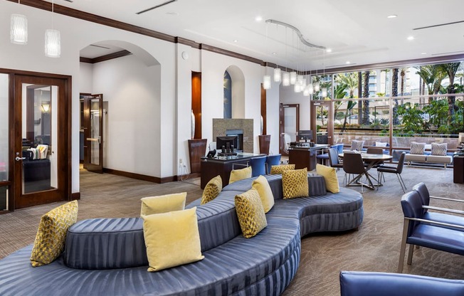 A living room with a grey couch and yellow pillows.