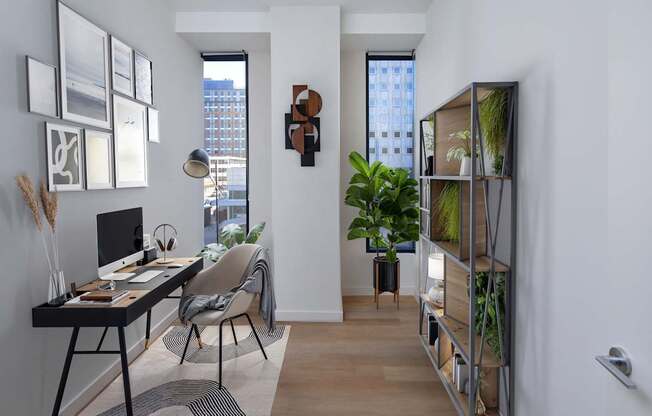 A room with a desk, chair, and a window.