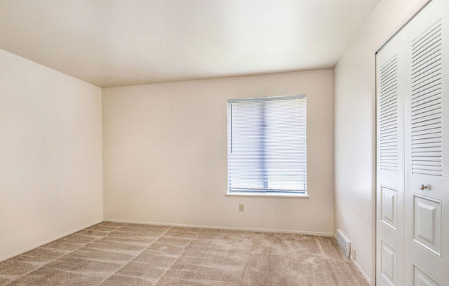 bedroom with large window at West Wind Apartments in Fort Wayne, IN
