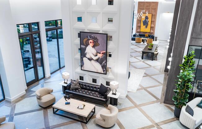 A double-height lobby at Modera Aventura, where sculptural wall detailing, gallery-style art, and layered seating create a bold yet welcoming gathering space.