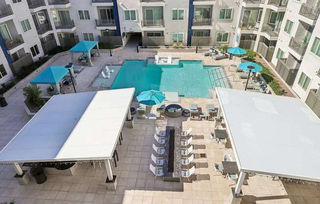 A large swimming pool surrounded by a white canopy.