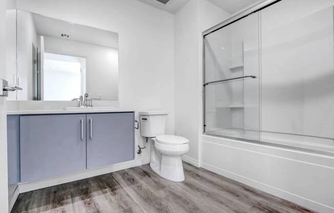 a white bathroom with a toilet and a shower